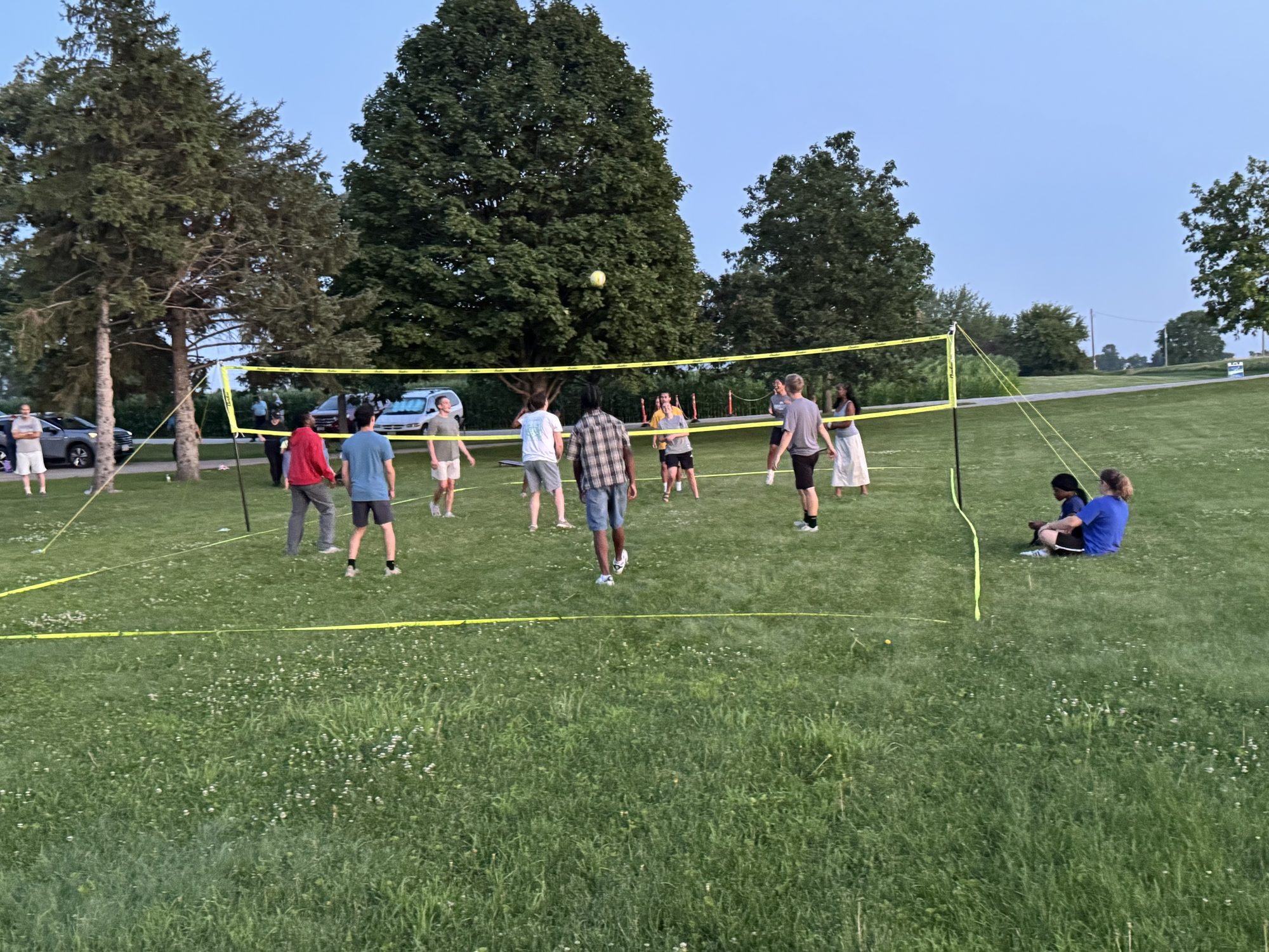 Adults from Crosspoint Baptist Church playing volleyball on a summer evening in Iowa City
